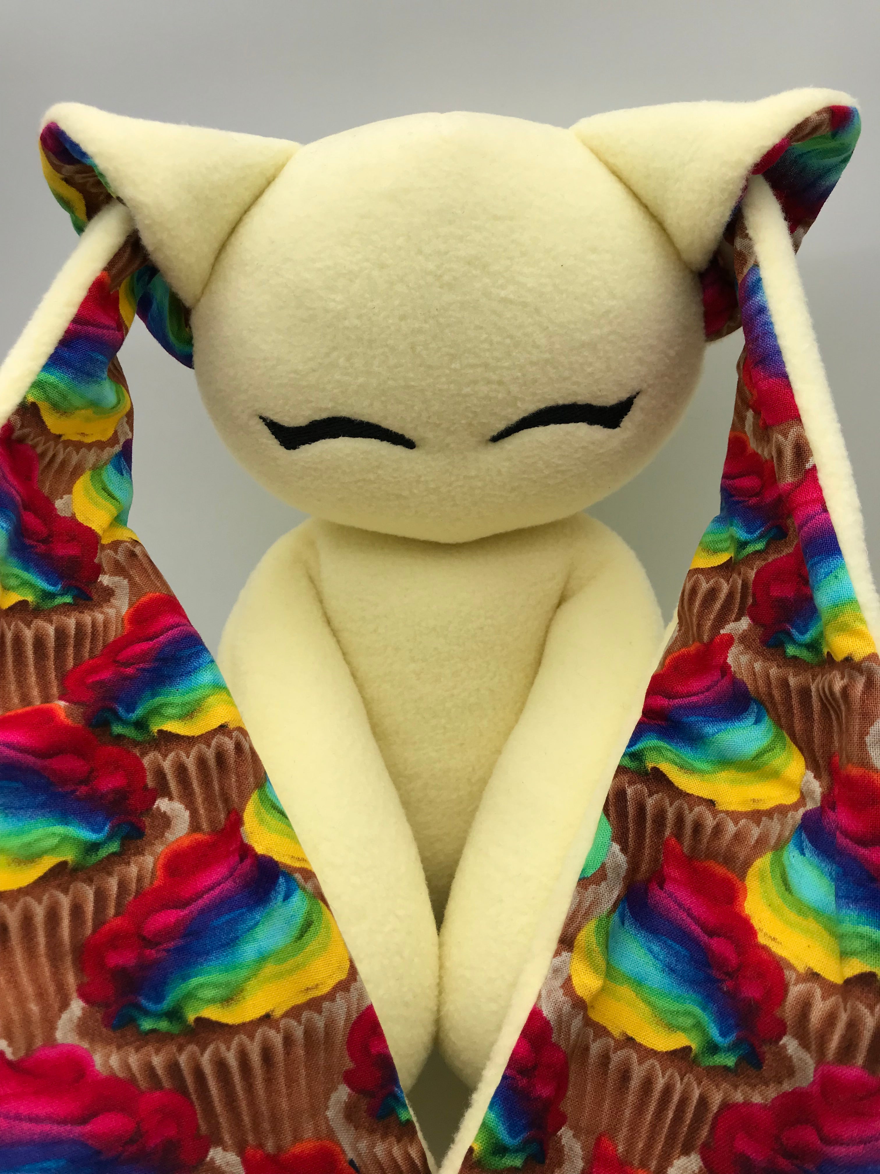 Yellow Cabbit with rainbow cupcakes